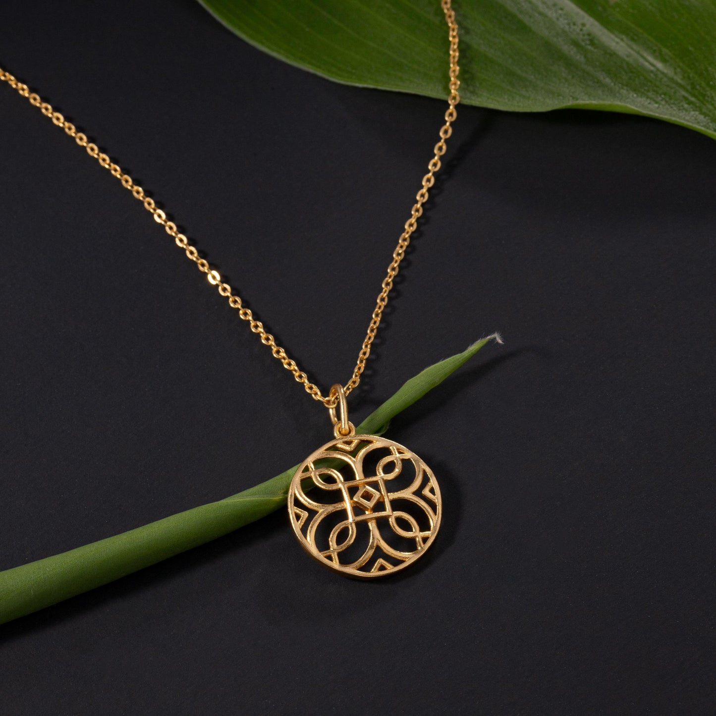 golden necklace with a celtic design pendant