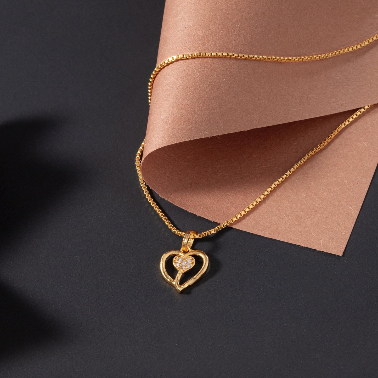 golden necklace with heart pendant