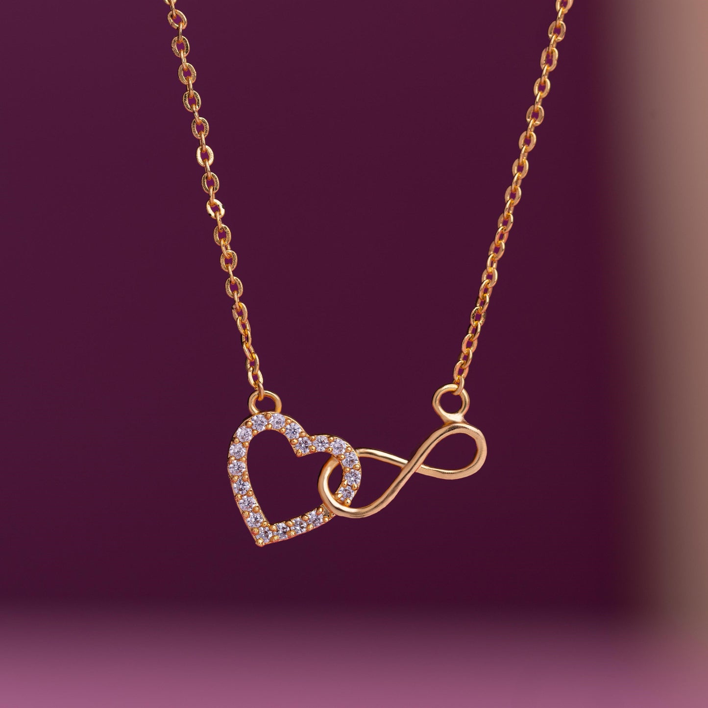 golden necklace with heart and infinity