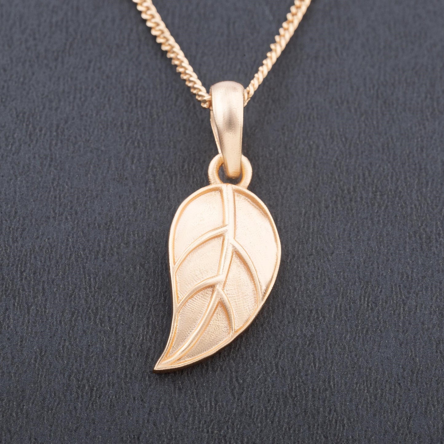 golden necklace with leaf pendant