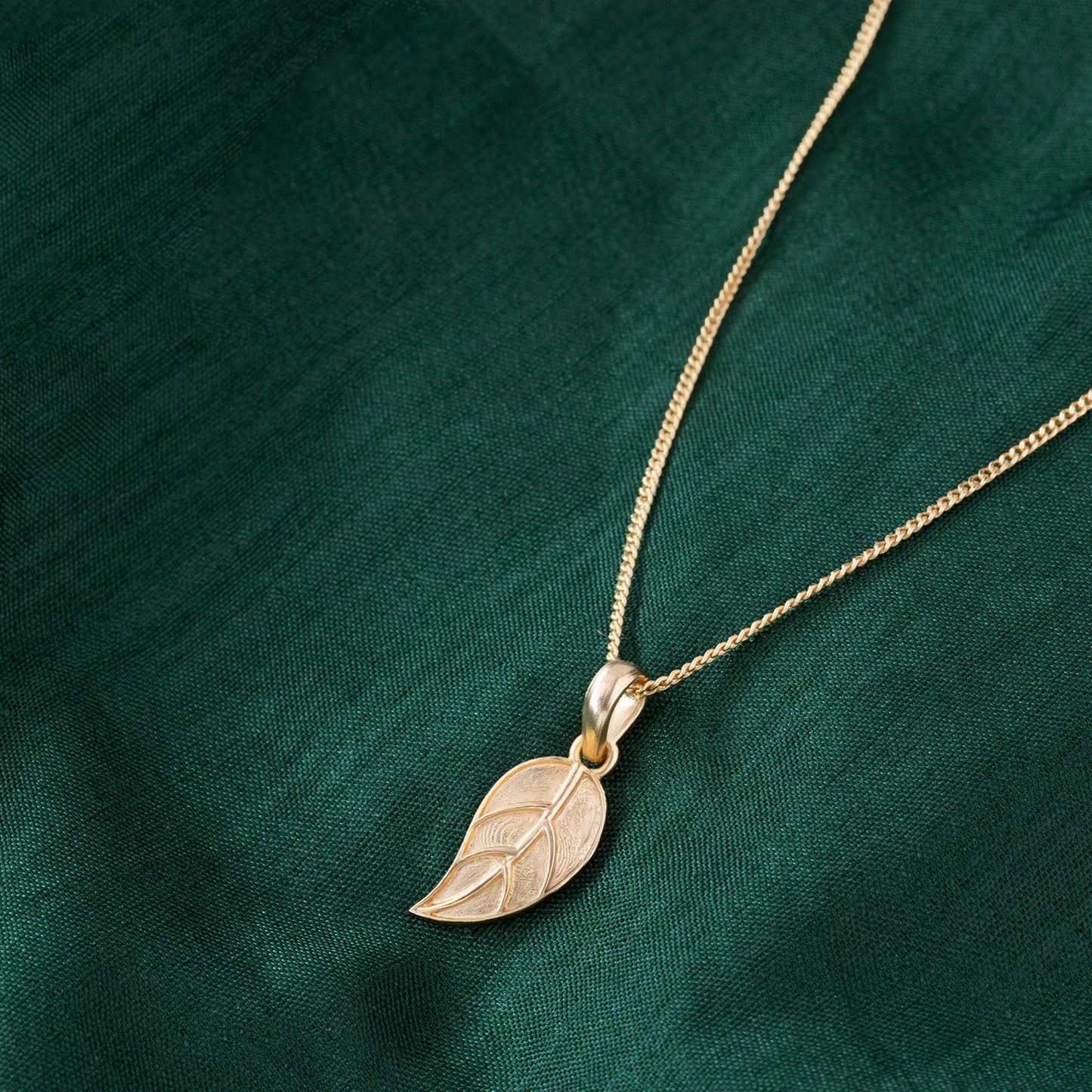 golden necklace with leaf pendant