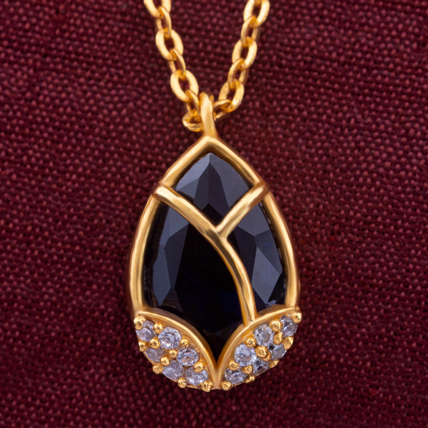 golden necklace with a large tear shaped pendant