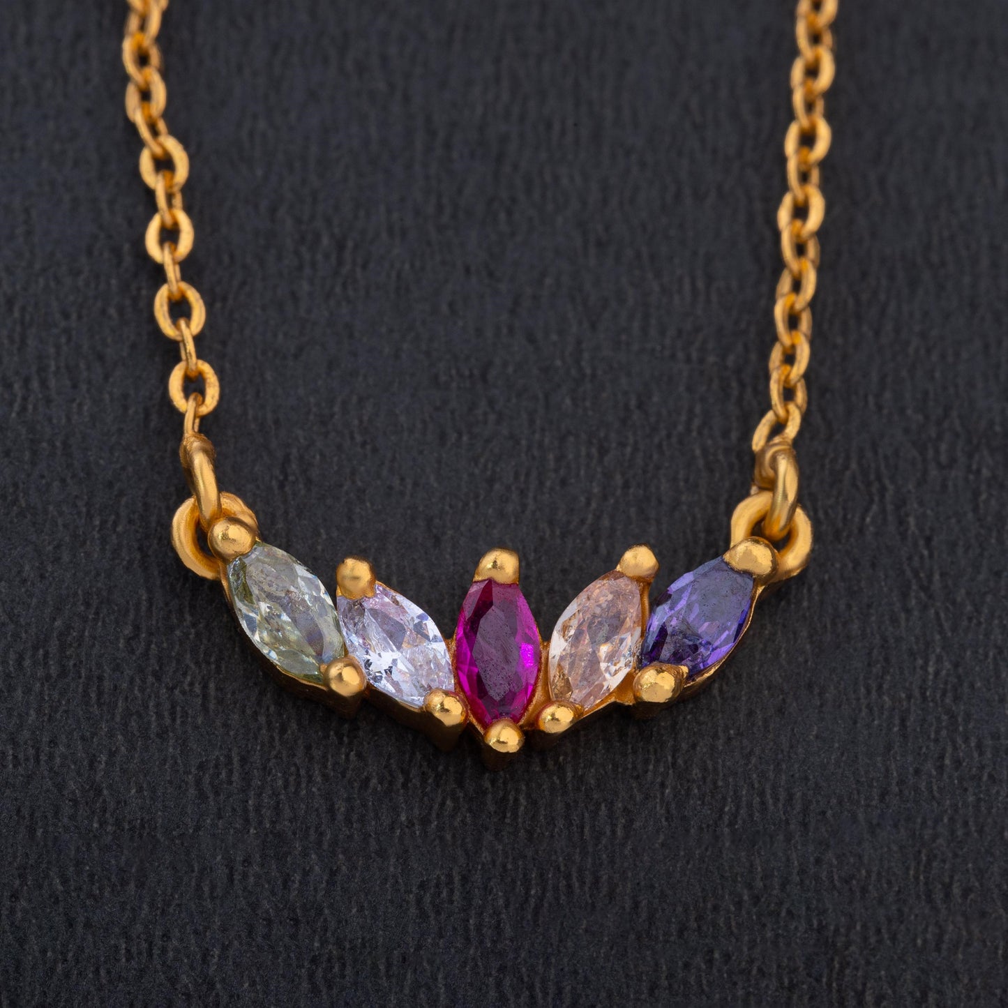 golden necklace with multi colored stone