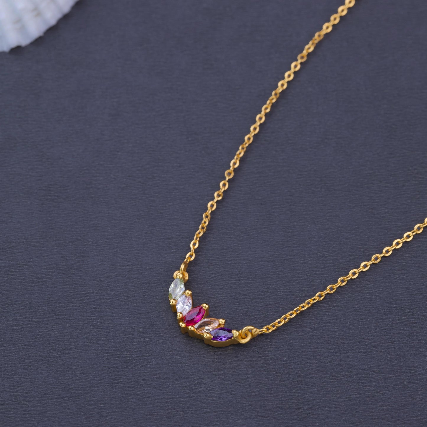 golden necklace with multi colored stone