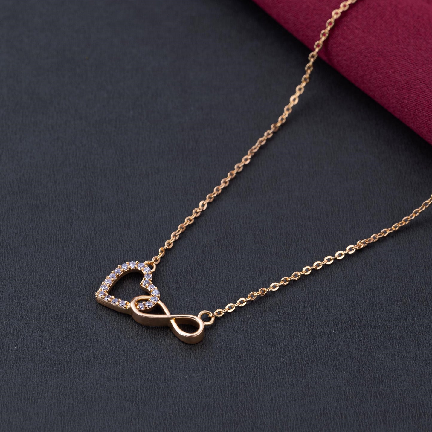 golden necklace with heart and infinity