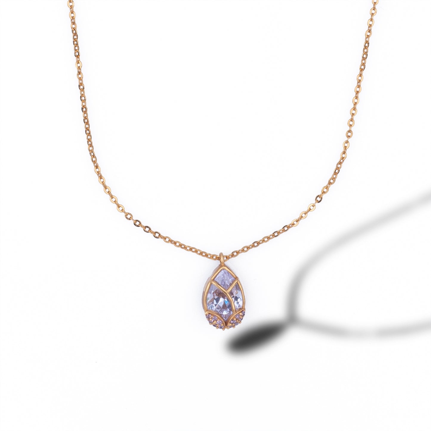 golden necklace with a large tear shaped pendant