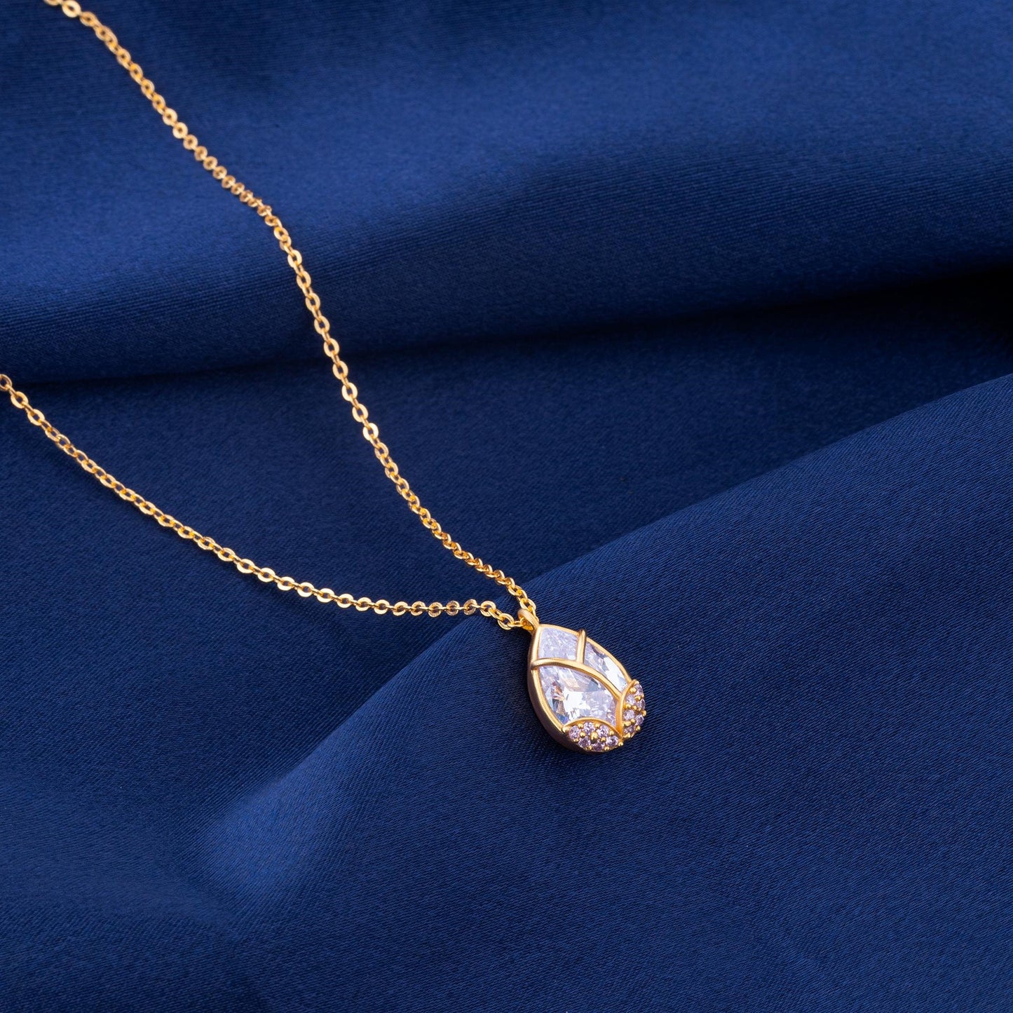 golden necklace with a large tear shaped pendant