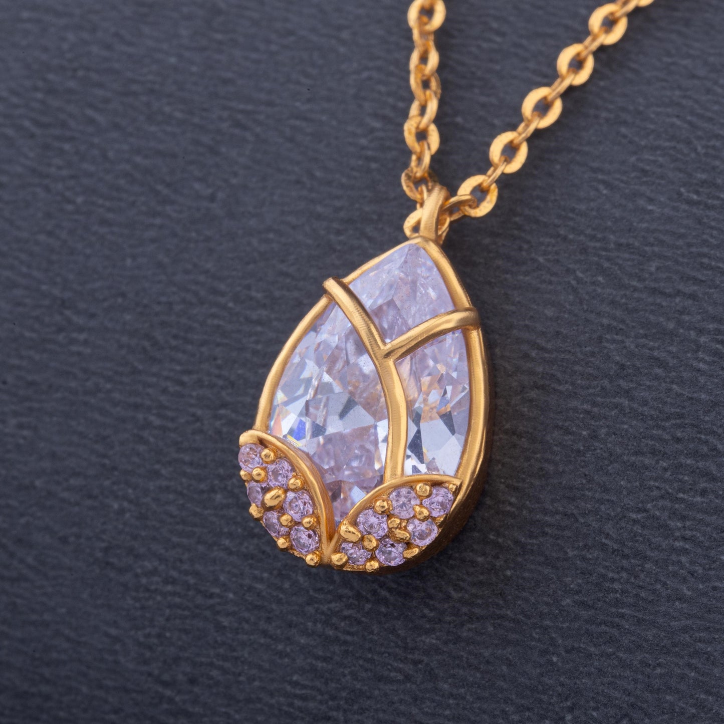 golden necklace with a large tear shaped pendant