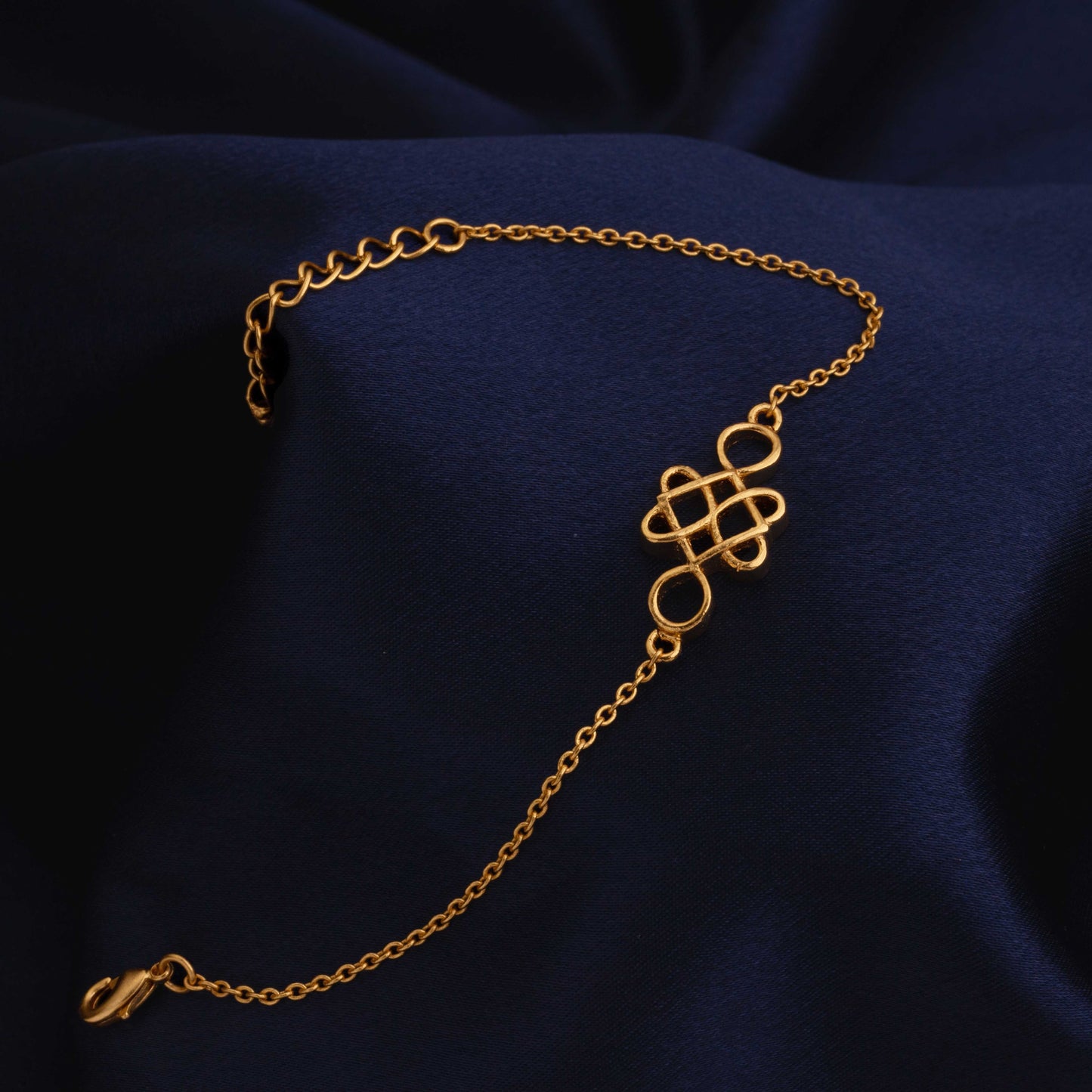 golden bracelet with a beautiful knot