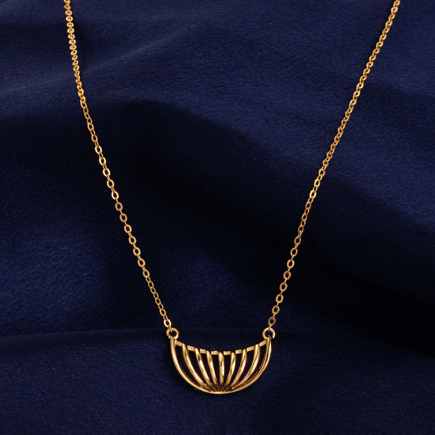 golden necklace with a large curved design