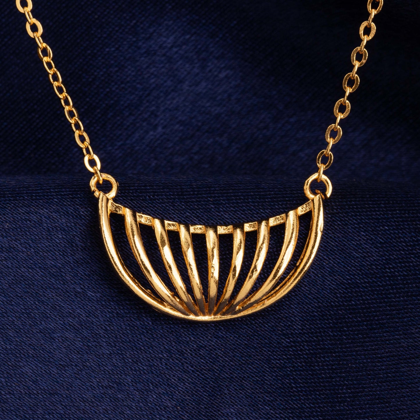 golden necklace with a large curved design