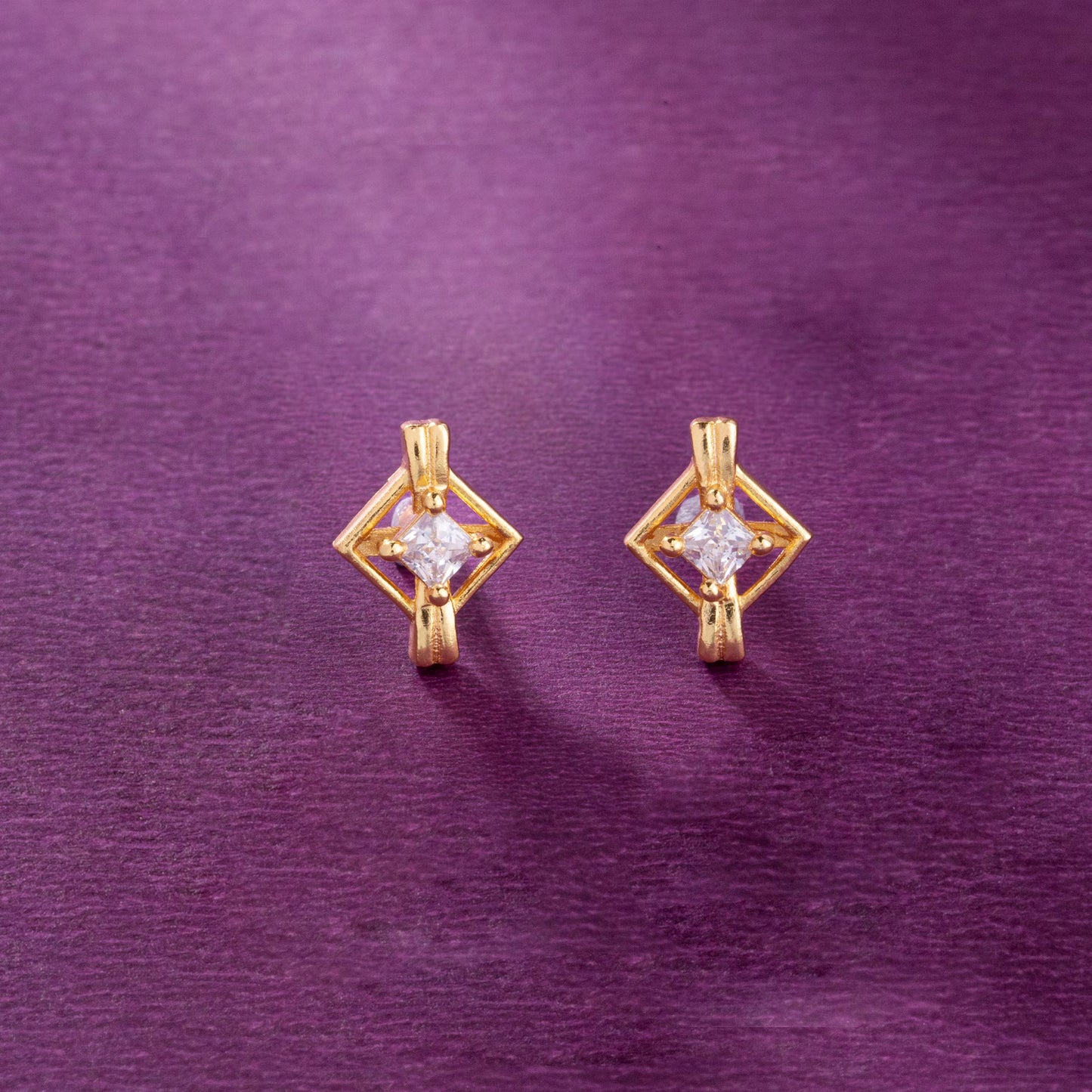 pair of golden earrings with a diamond