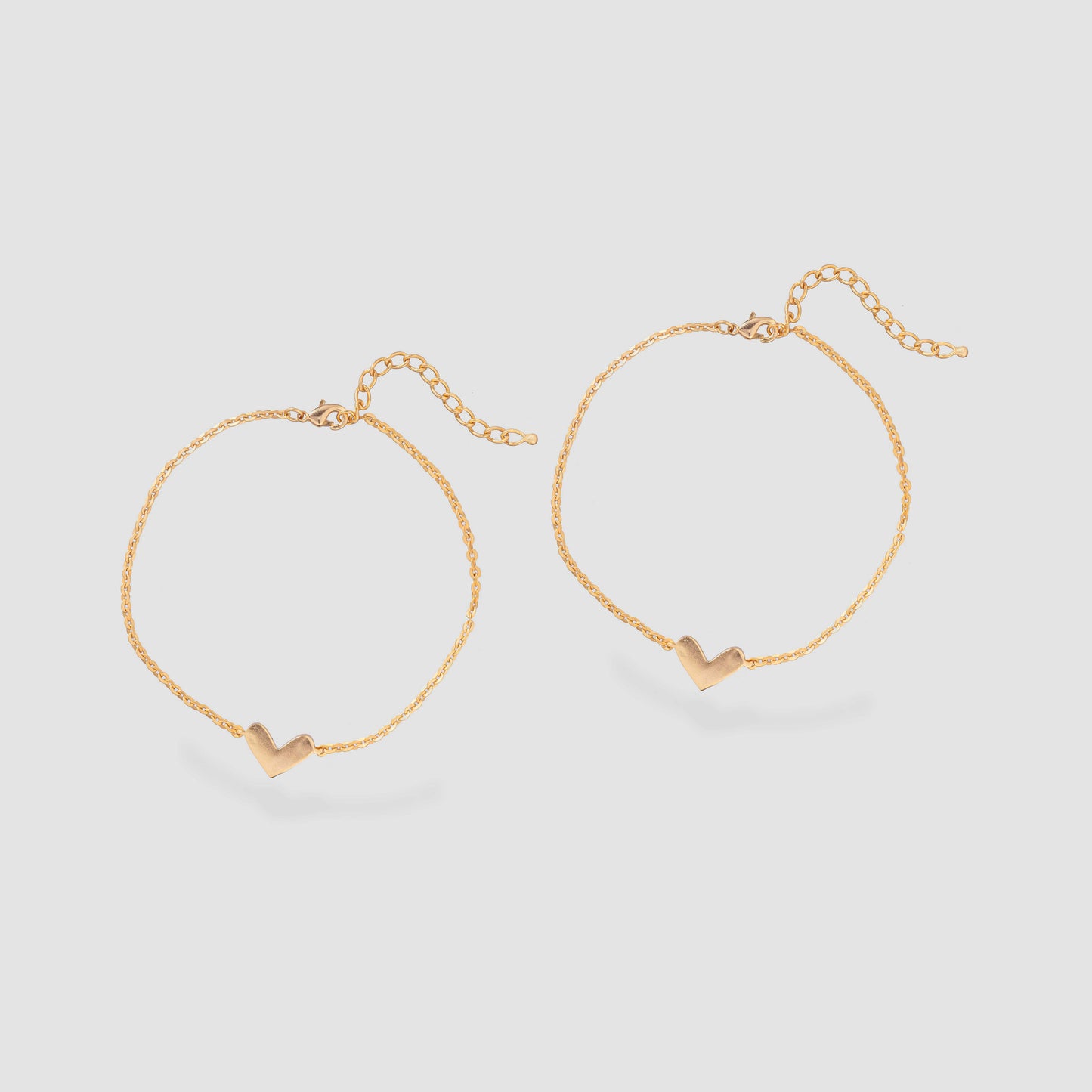 pair of golden anklet with a heart