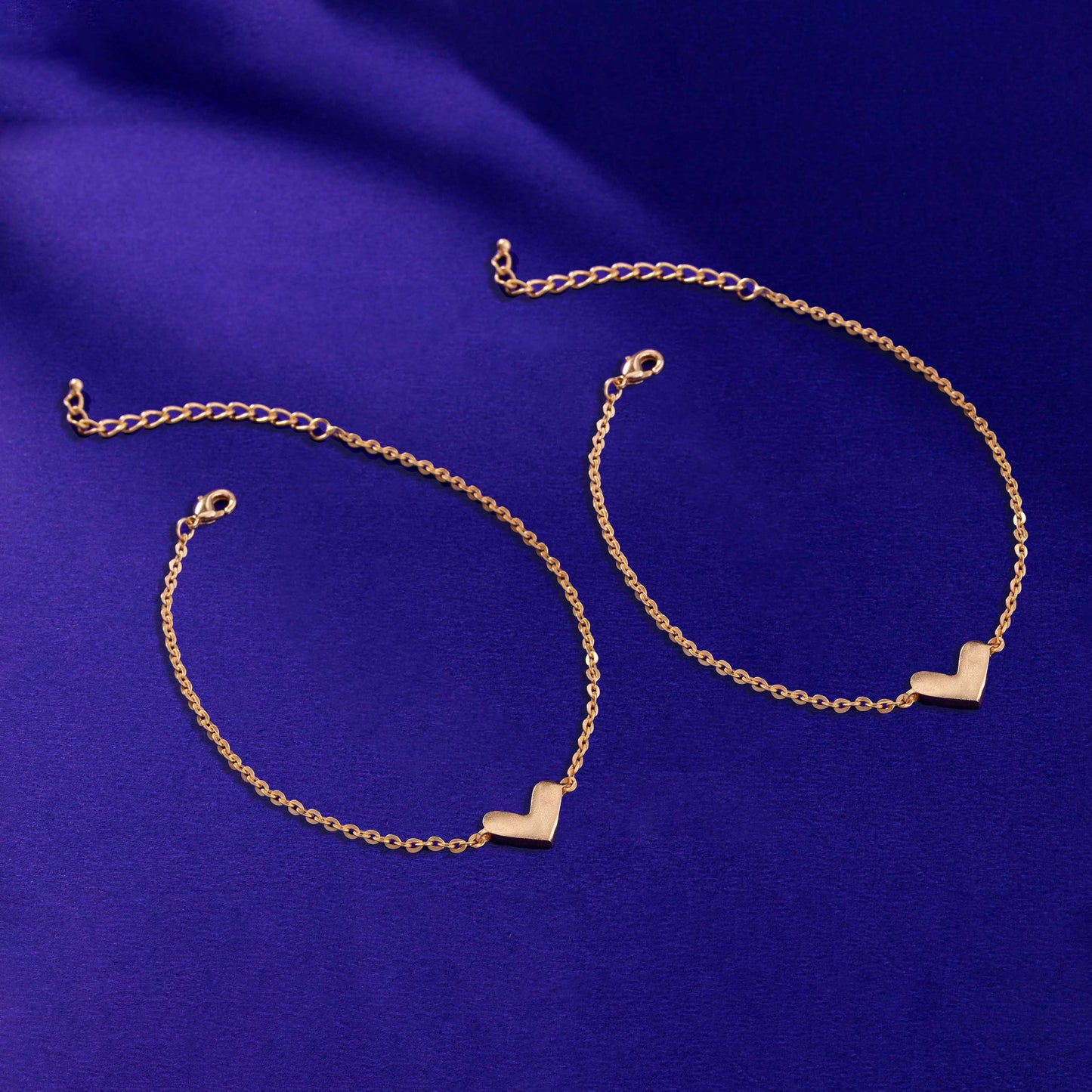 pair of golden anklet with a heart