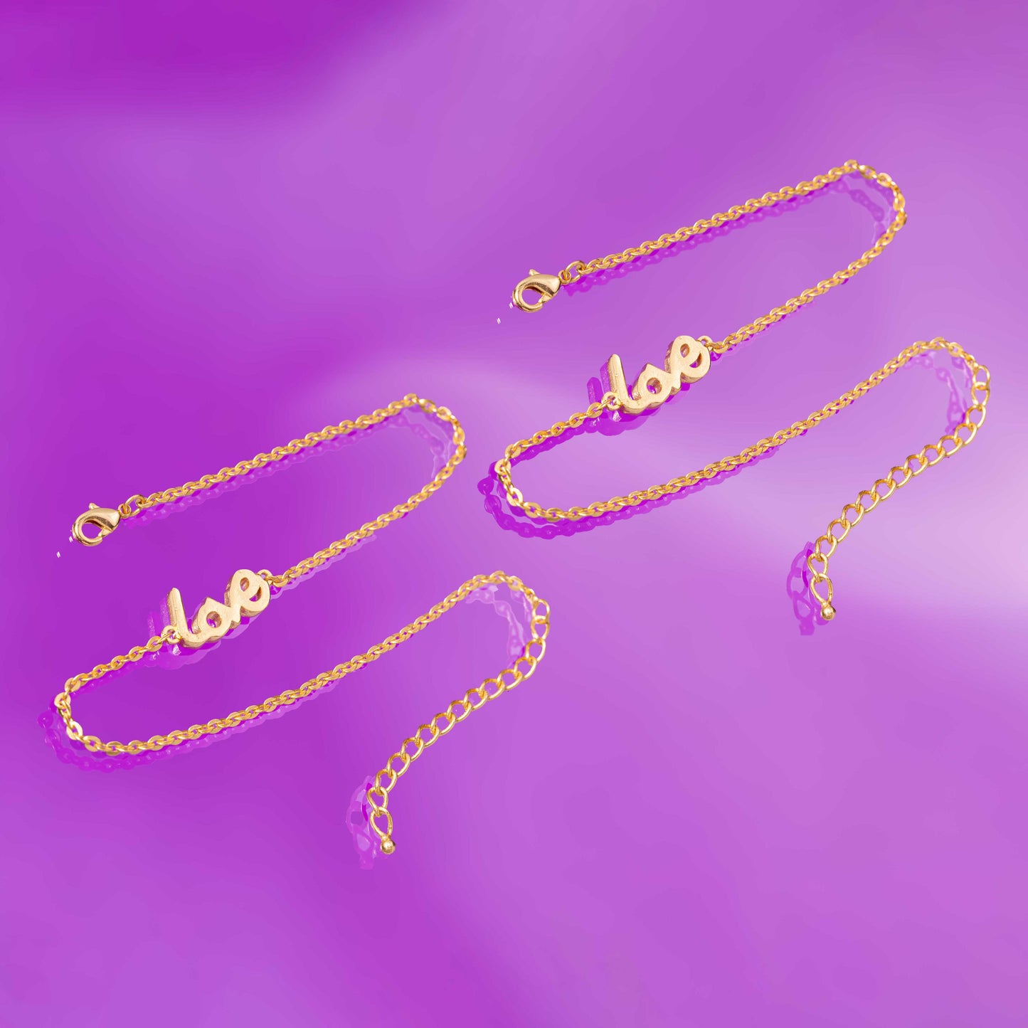 pair of golden anklet with the word love