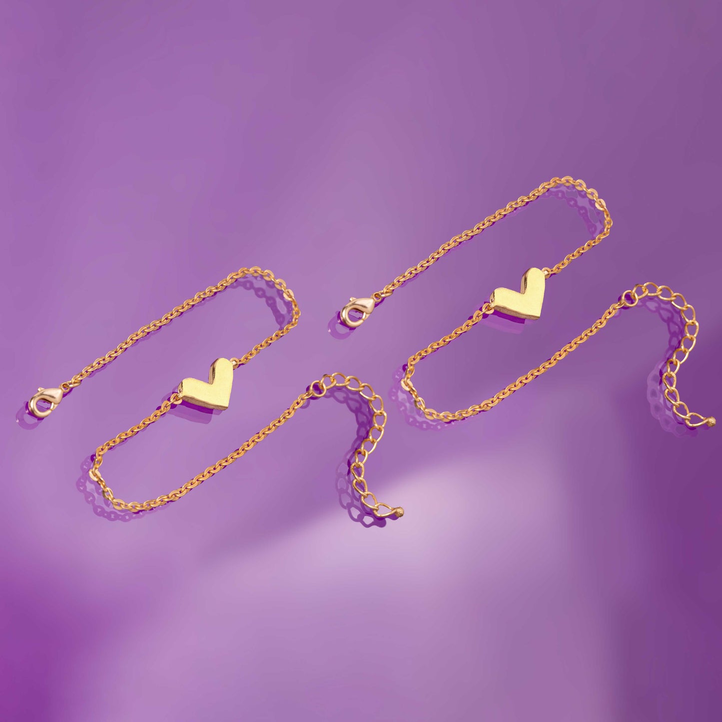 pair of golden anklet with a heart