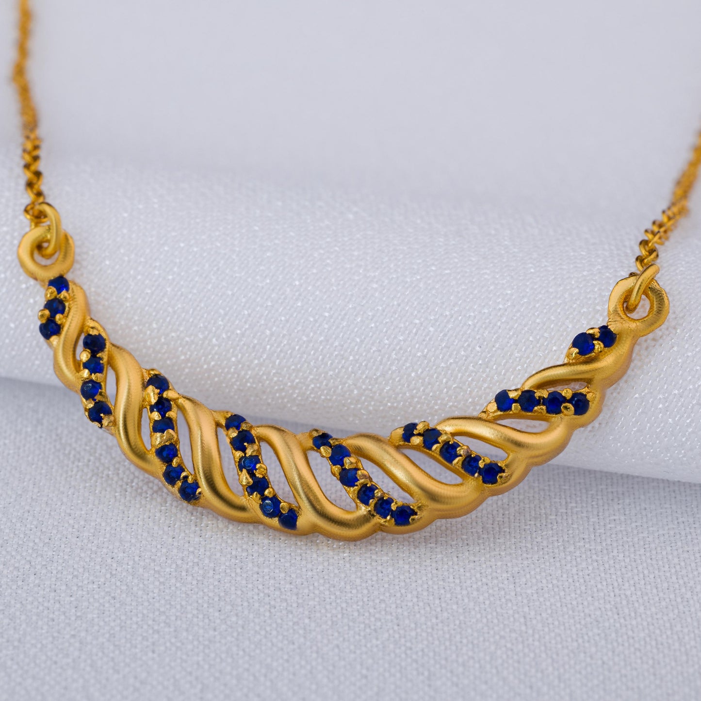 golden necklace with sapphire stones