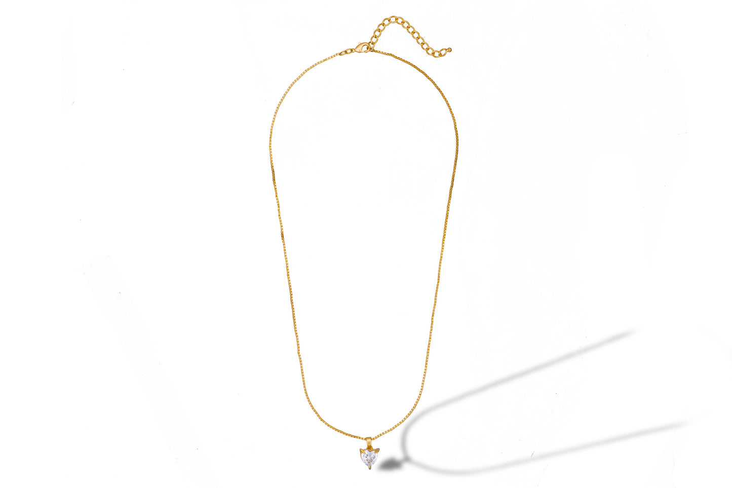 golden necklace with white heart pendant