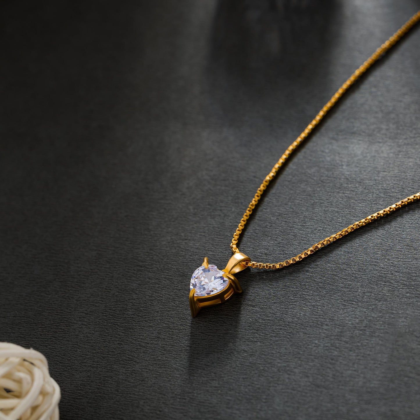 golden necklace with white heart pendant