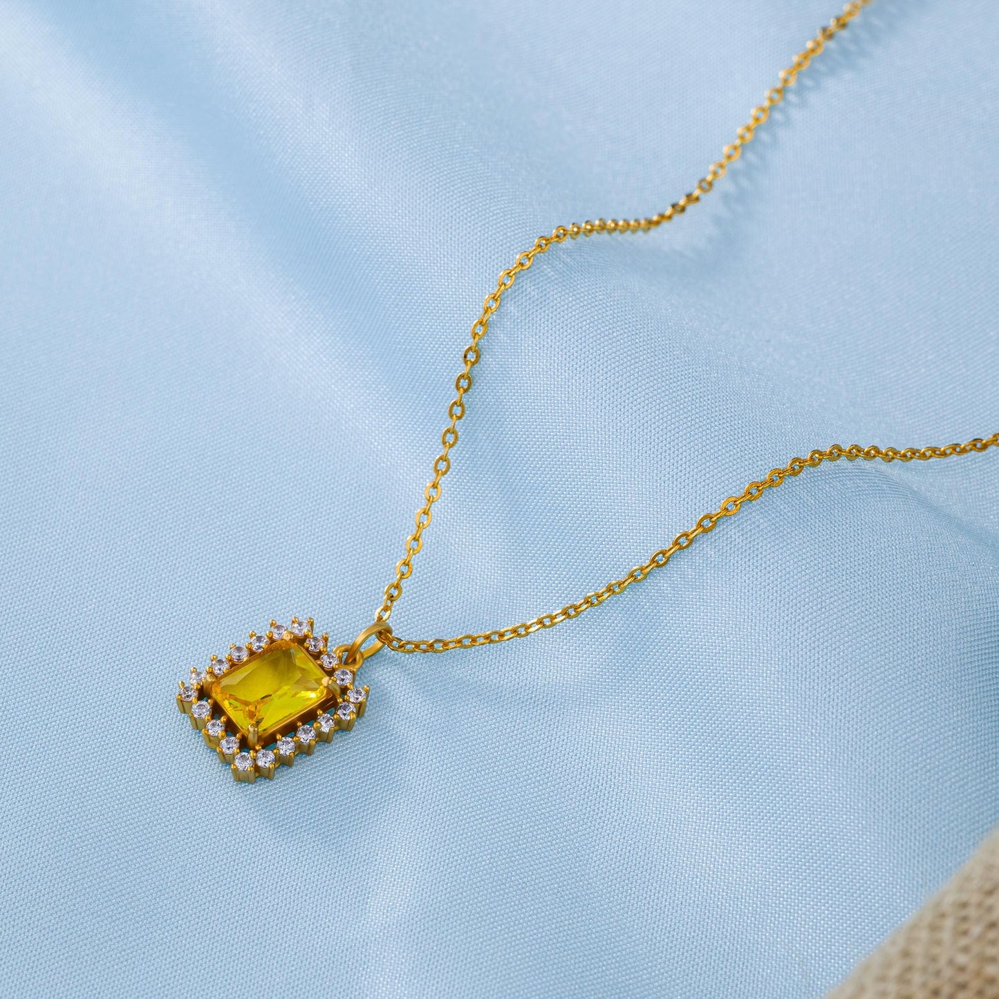 golden necklace with a two color stone