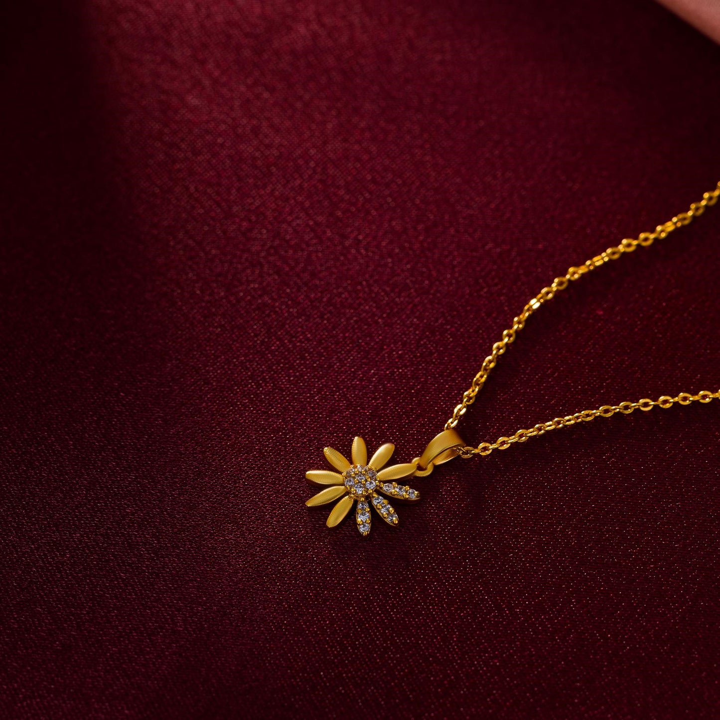 golden necklace with a flower pendant