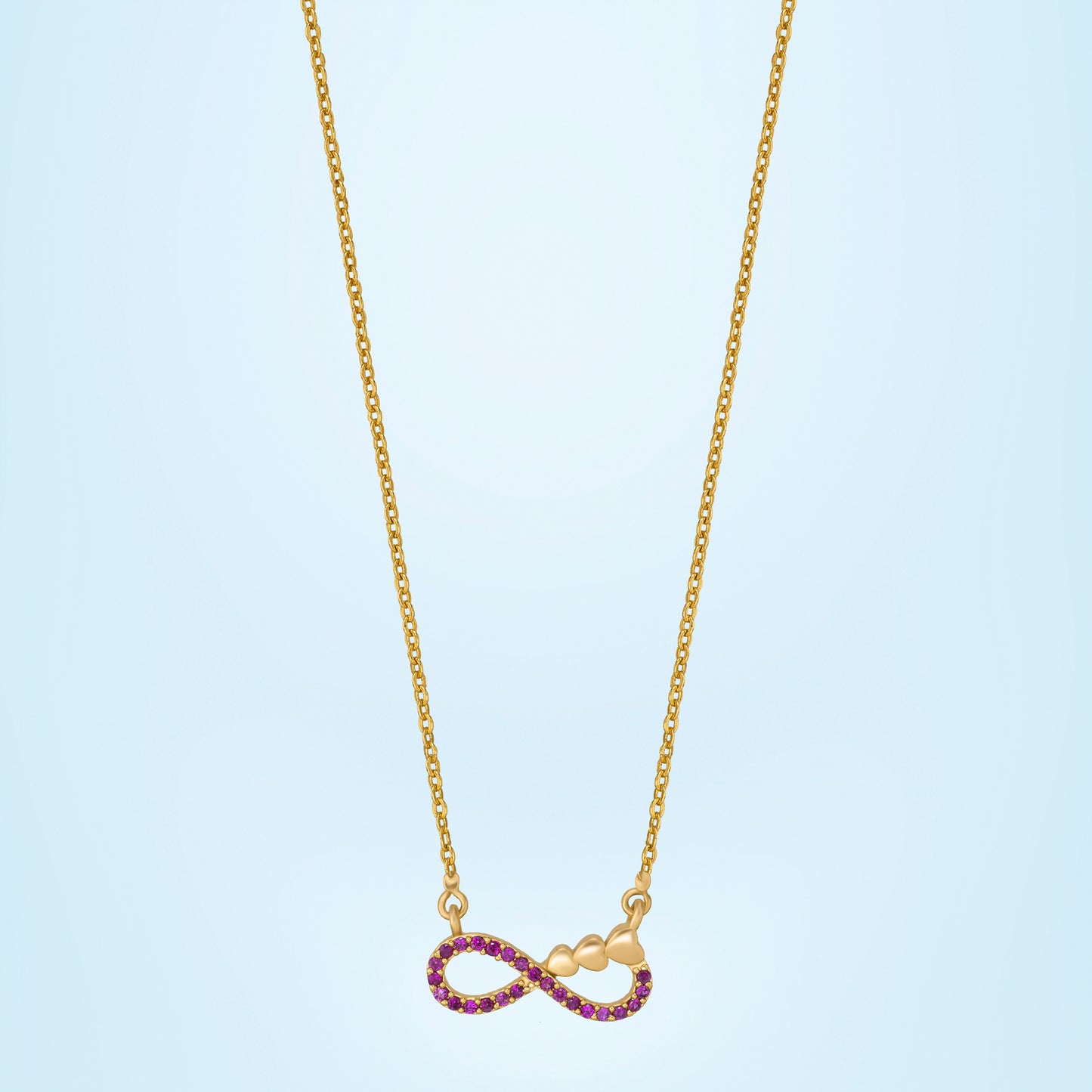 shine bright with this stunning golden necklace featuring a red infinity