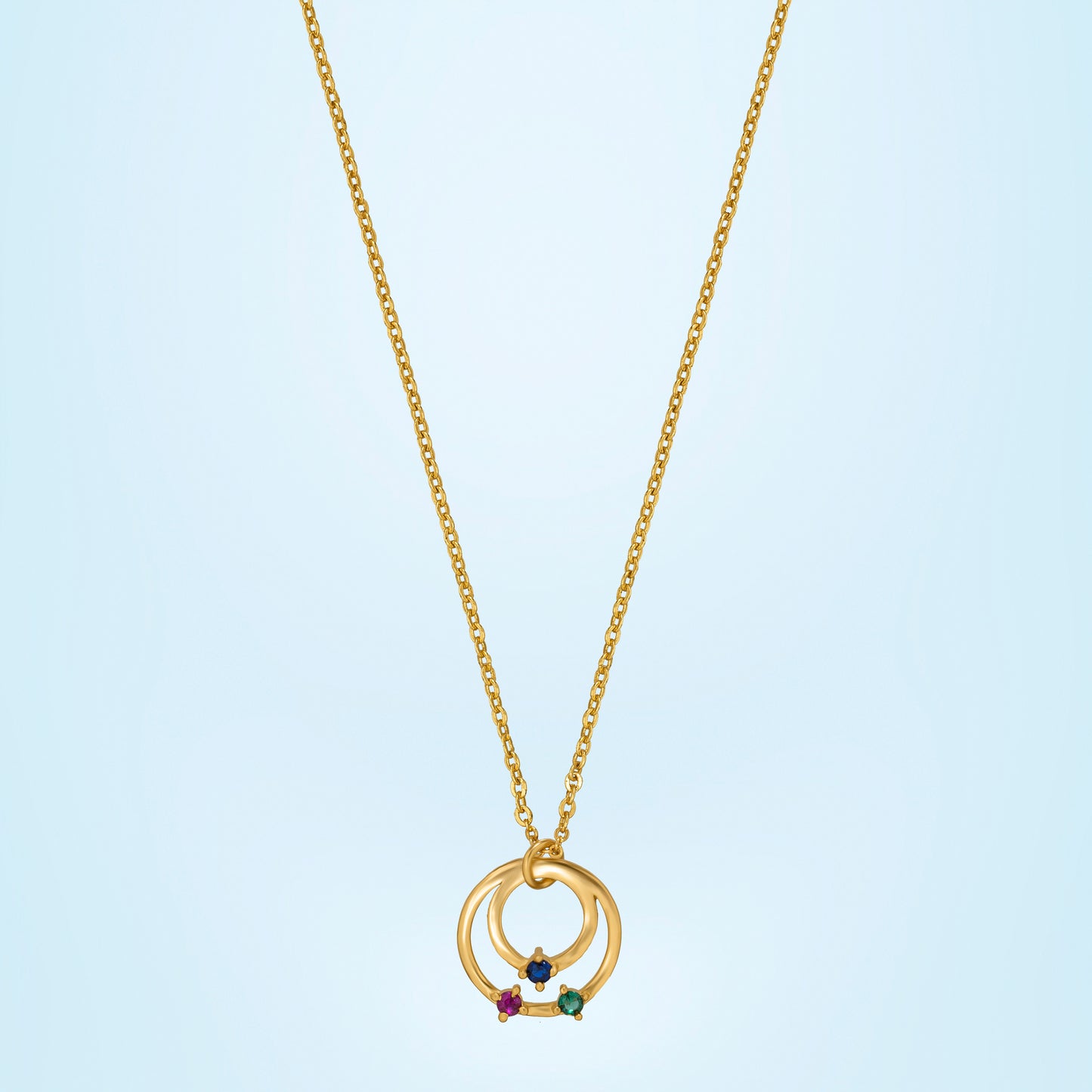 golden necklace with circle pendant and rainbow stones