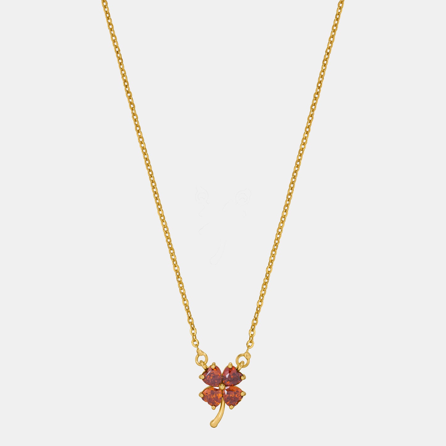 golden necklace featuring a four-leaf clover pendant