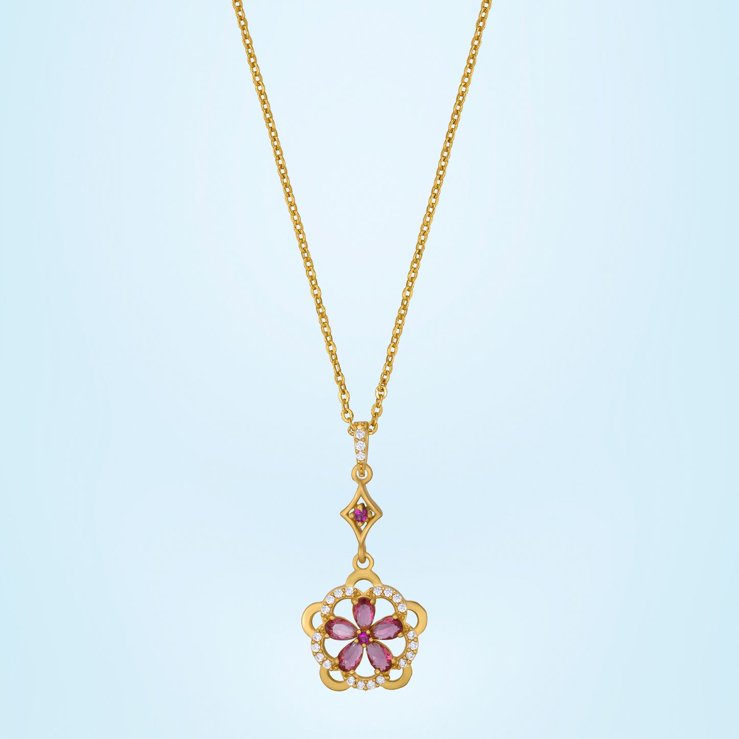 golden necklace adorned with a striking red flower pendant