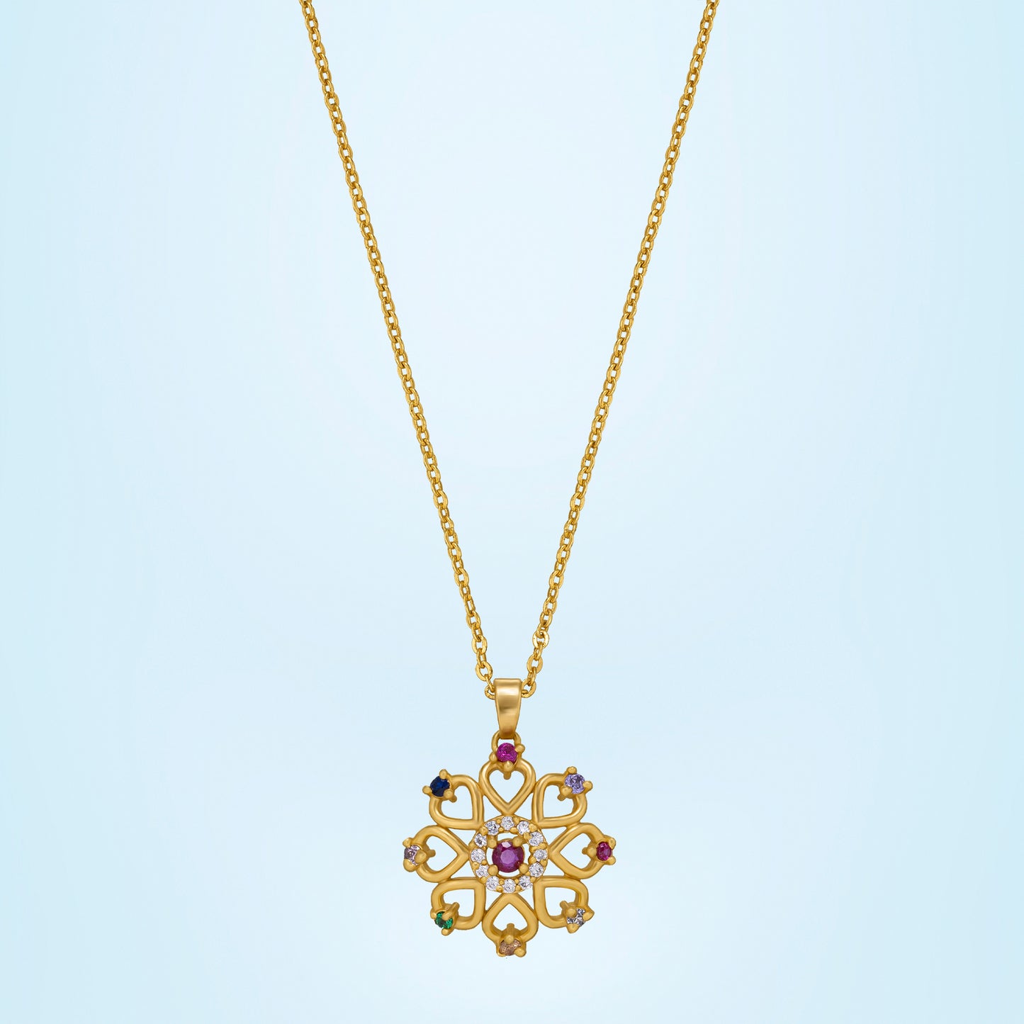 golden necklace with a flower design and multi colored stones