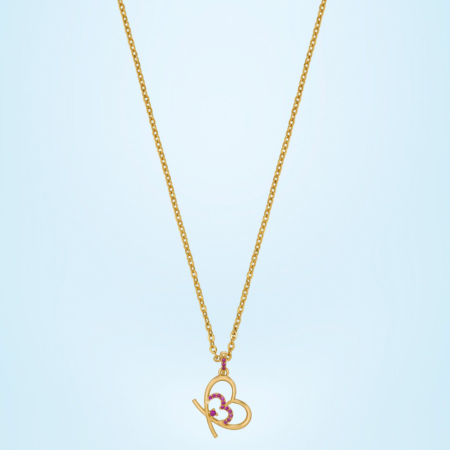 golden heart necklace adorned with pink stones