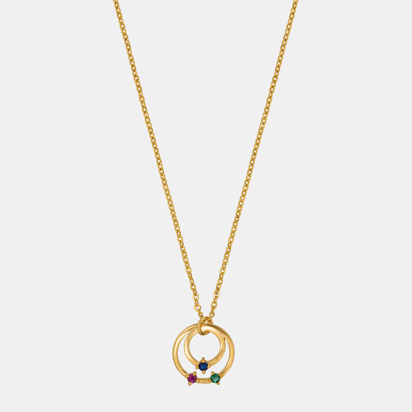 golden necklace with circle pendant and rainbow stones