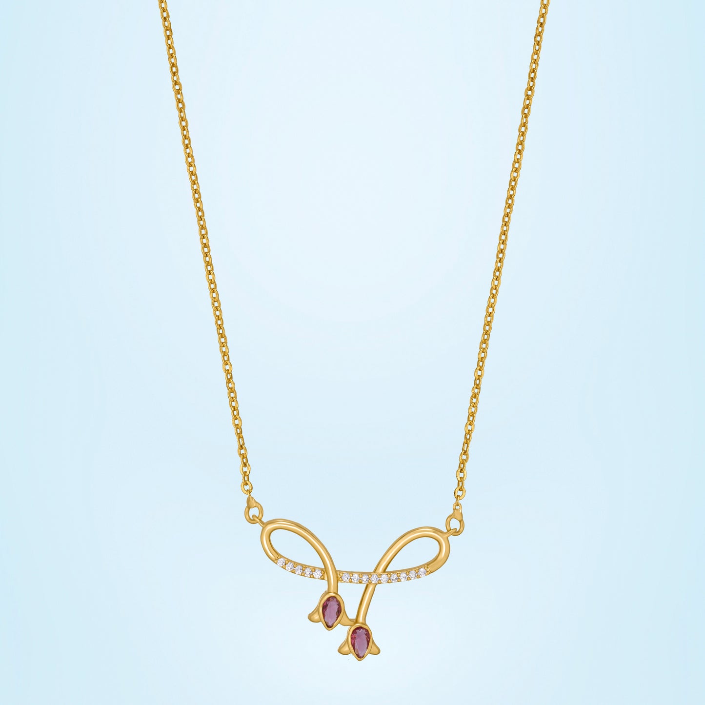 golden necklace with red stone and diamonds