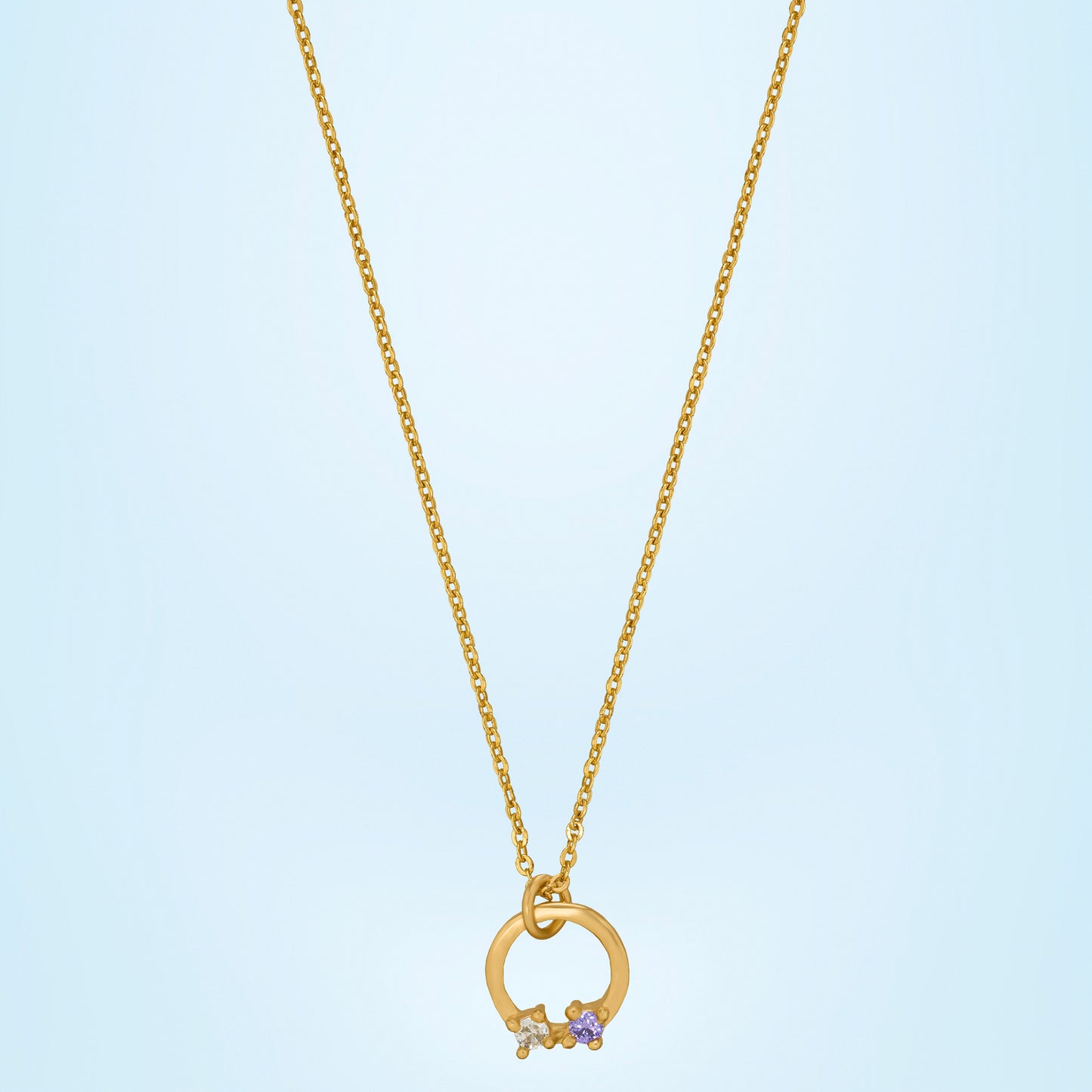 stylish golden necklace featuring circle pendant with white stone