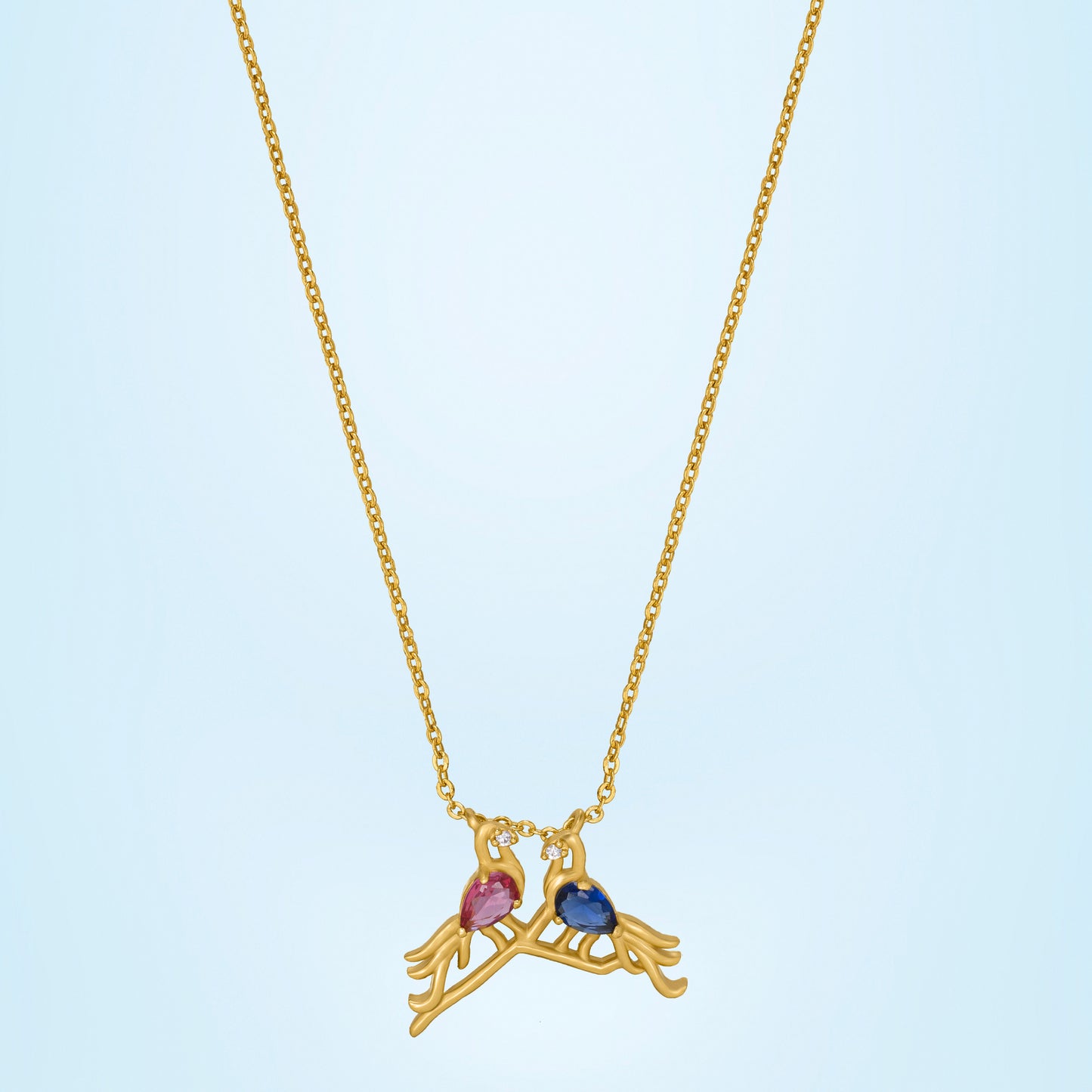 golden necklace with a bird and a heart