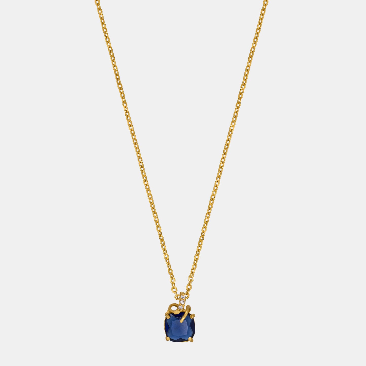 golden necklace with a sapphire stone