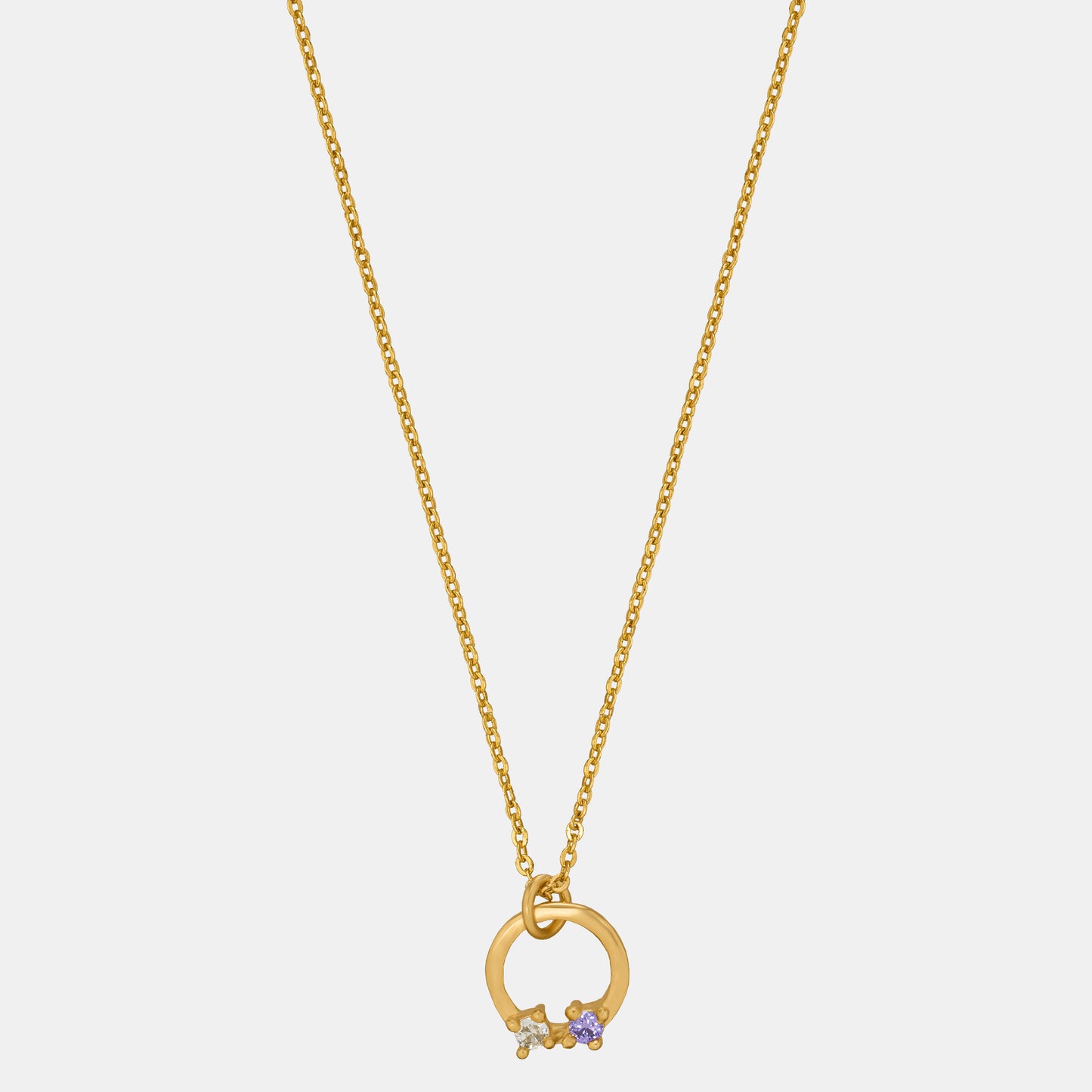 stylish golden necklace featuring circle pendant with white stone