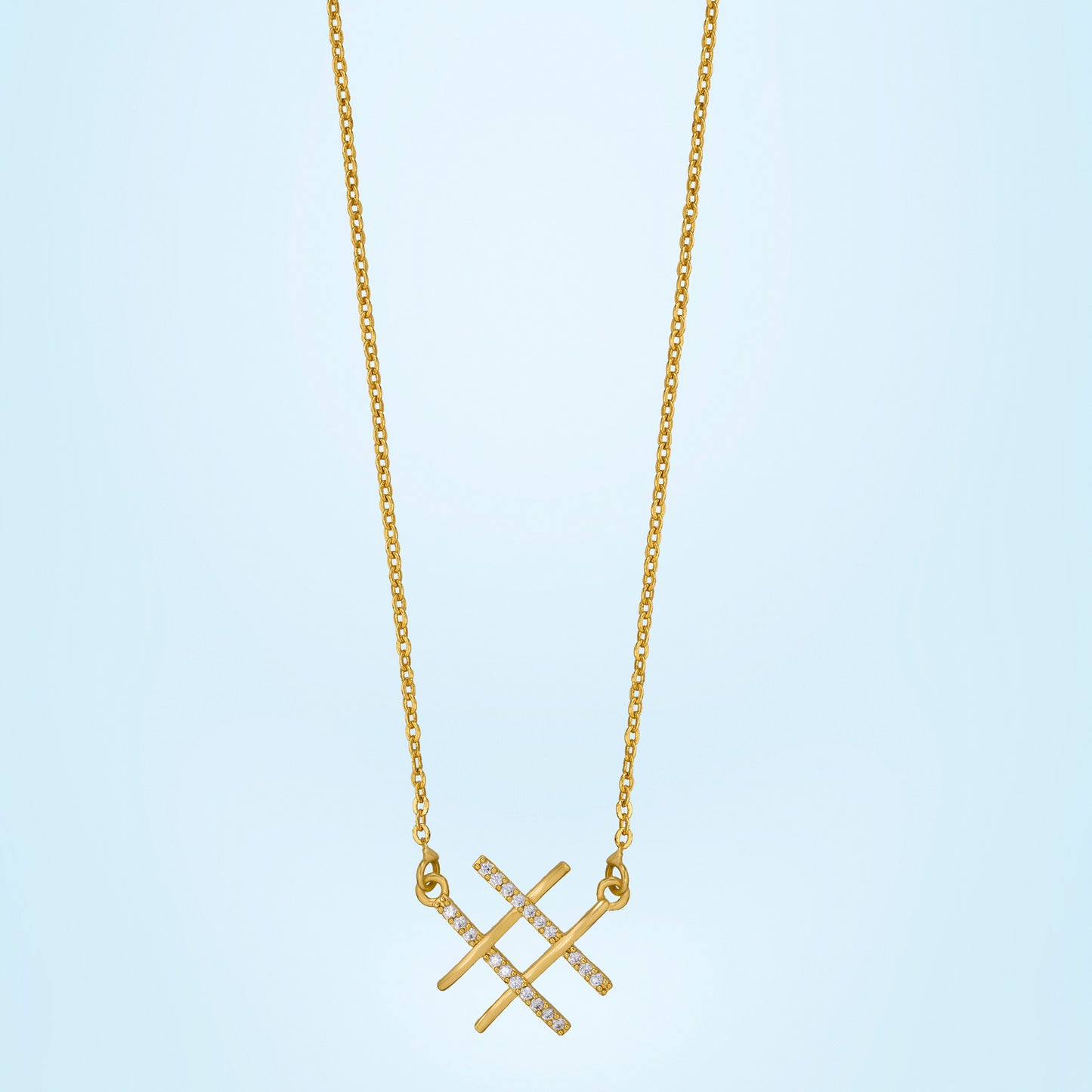 golden necklace with two crossed crosses on it