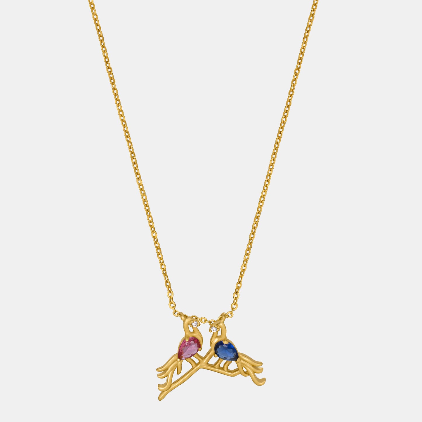 golden necklace with a bird and a heart