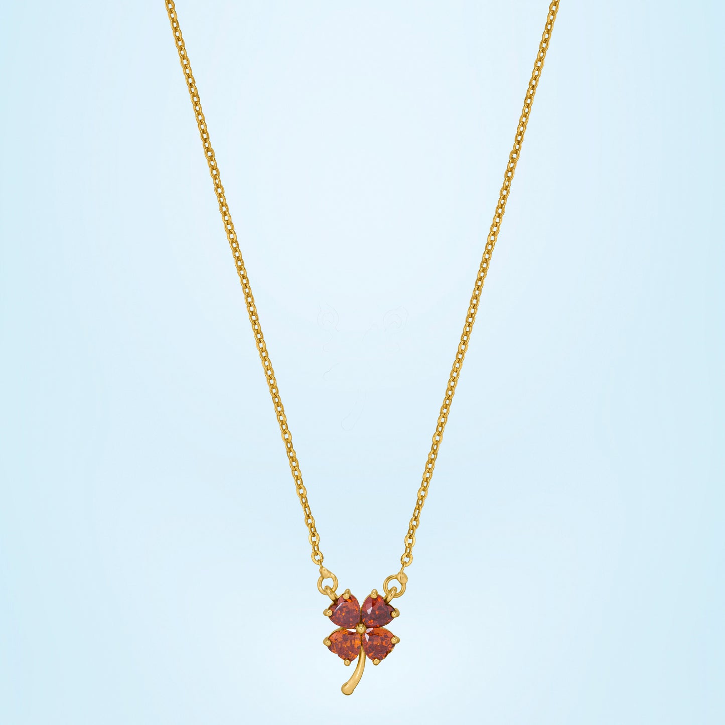 golden necklace featuring a four-leaf clover pendant