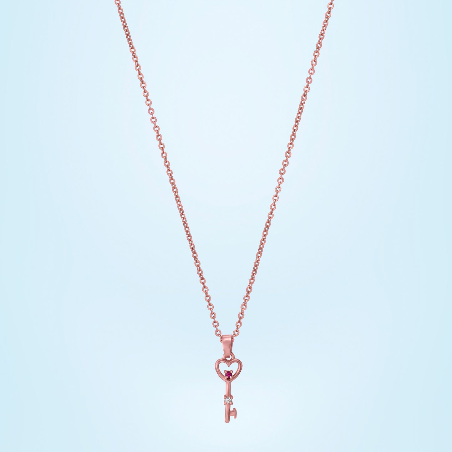 rose gold necklace with a heart and a key