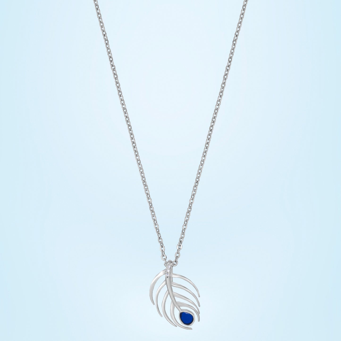 silver necklace with a blue stone