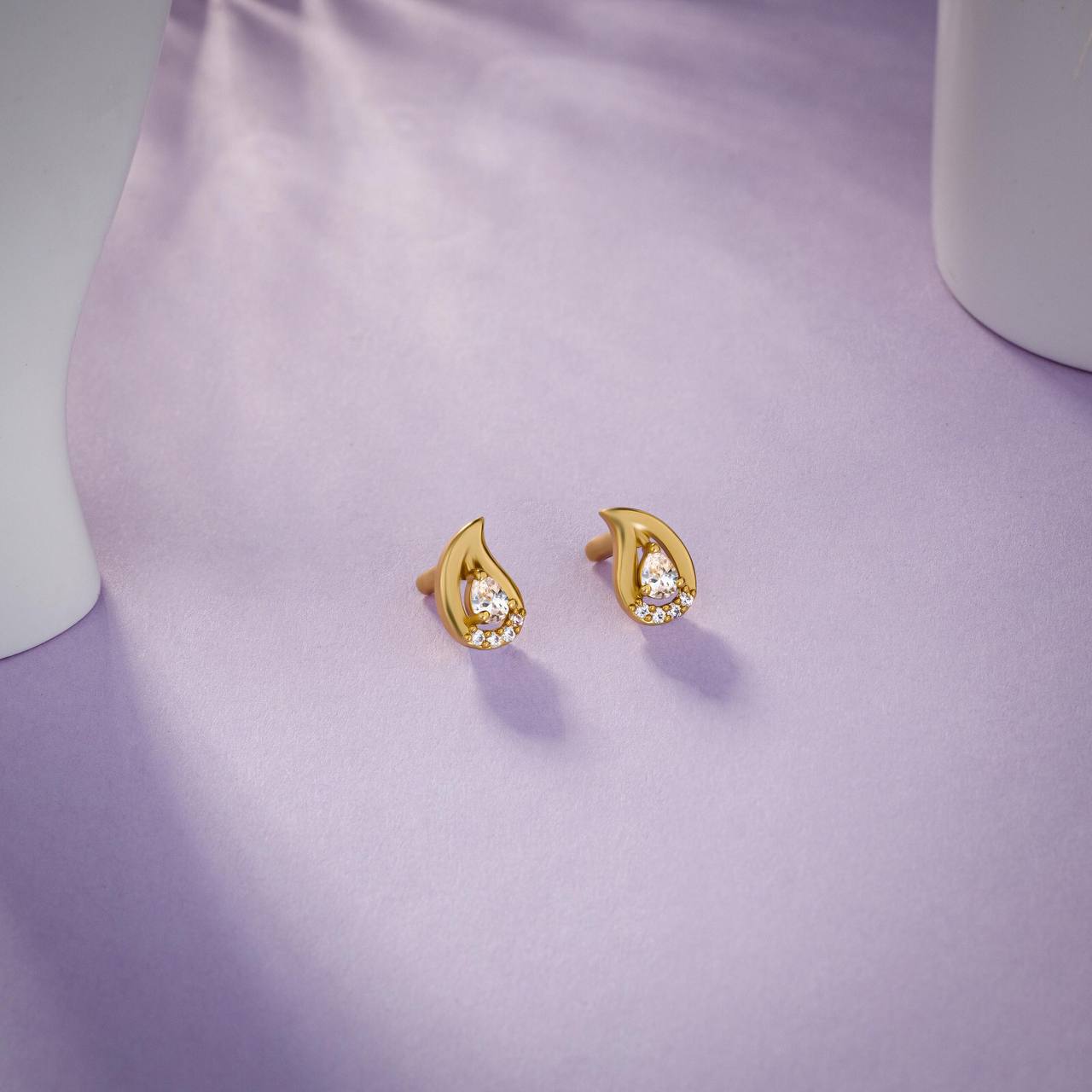 pair of golden earrings with white stones