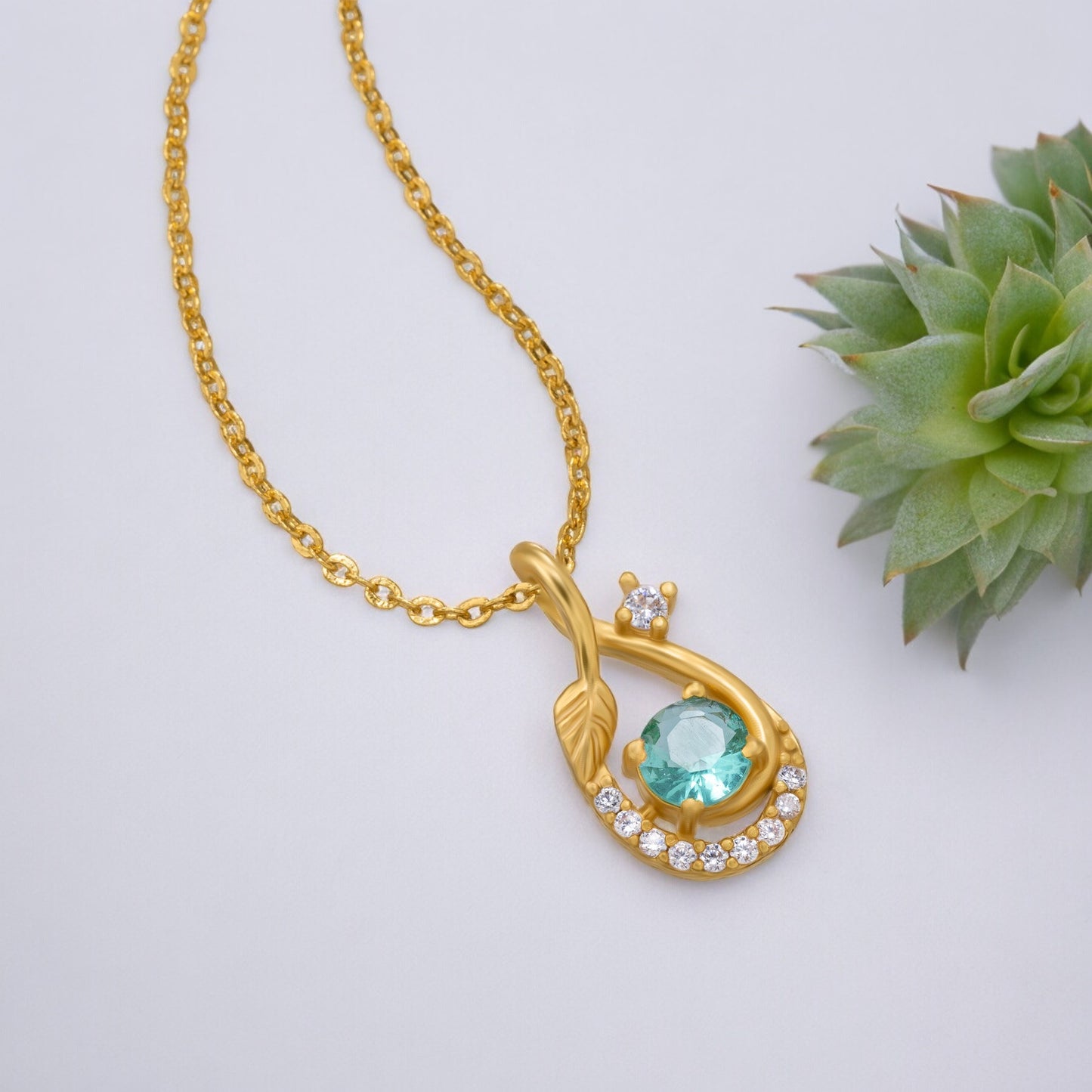 golden necklace with a stone and diamonds