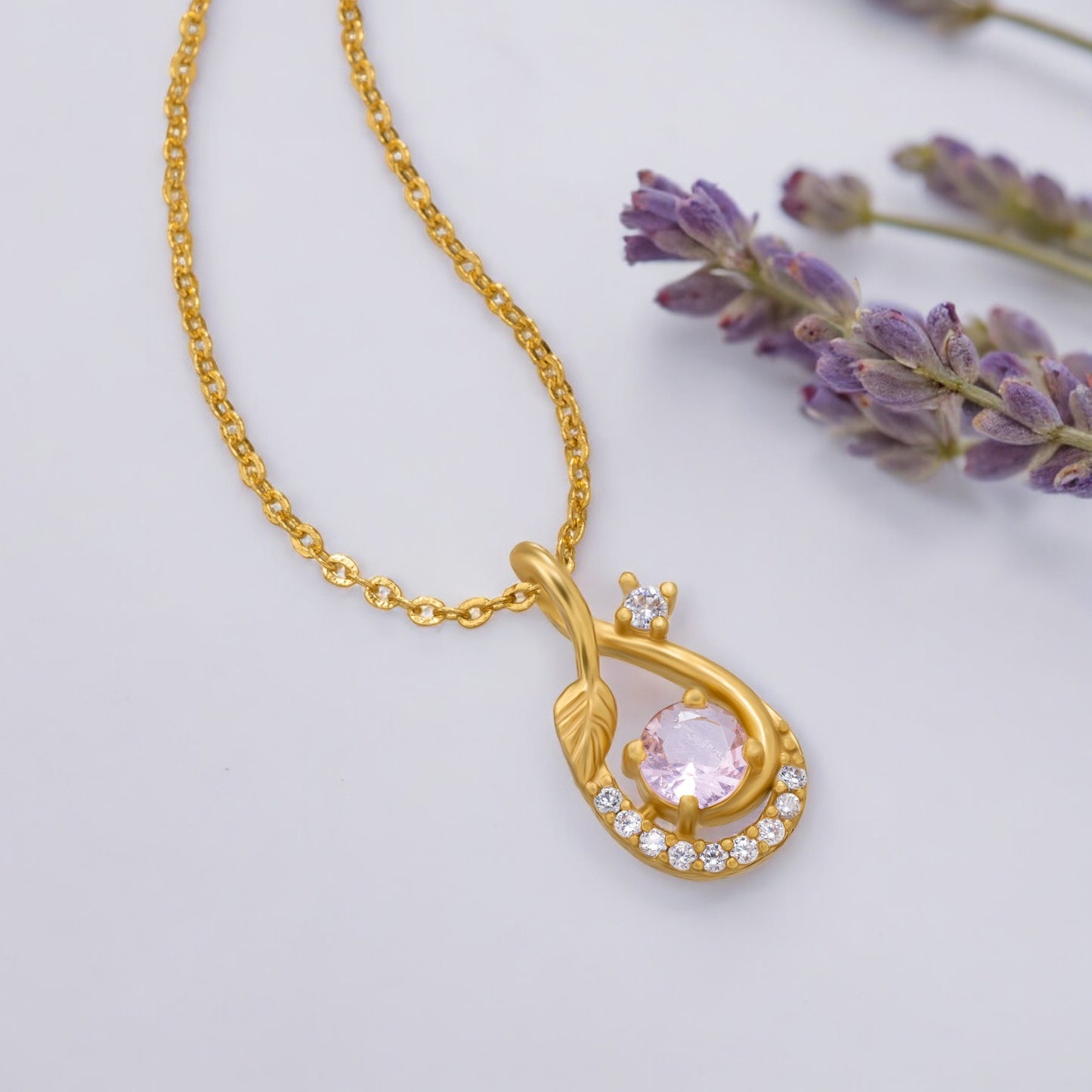 golden necklace with a stone and diamonds